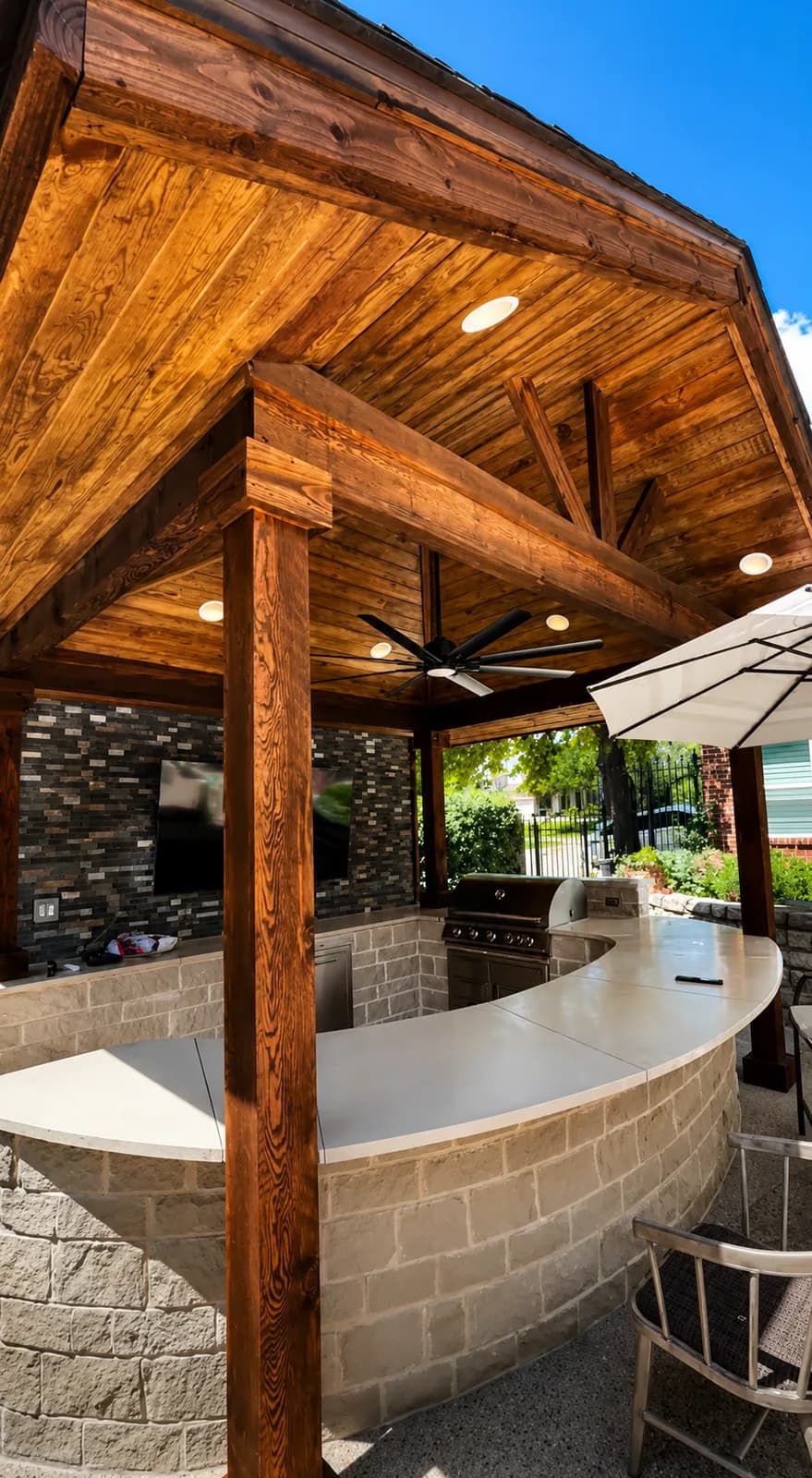 Curved stone bar under a stained cedar ceiling.